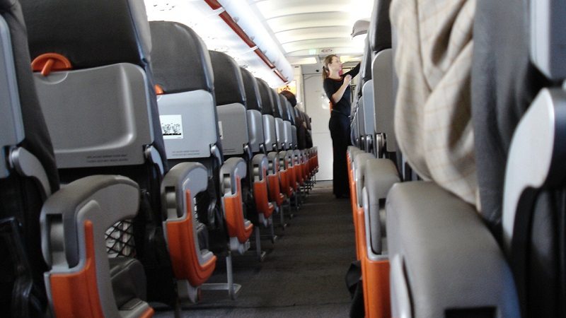 Conquer the Armrest On Your Flight by Reclining Your Seat First